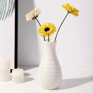 A single Nordic-style plastic vase in white, featuring a bohemian design, serves as a simple and compact storage solution for fresh flowers. This elegant flower pot is ideal for modern home decorations and ornaments, particularly in living room settings